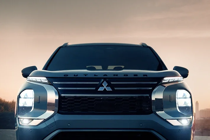 The Outlander’s LED headlights and fog lights at dusk