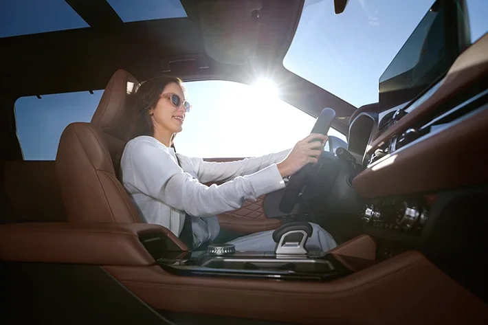 A woman driving the 2026 Outlander