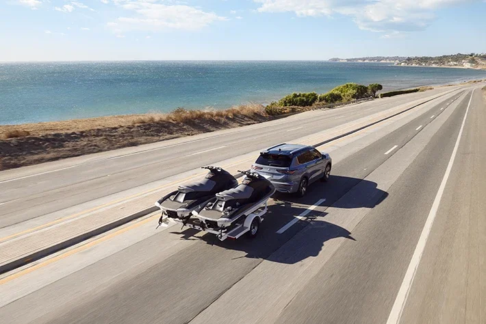 The Outlander towing two jet skis on a trailer