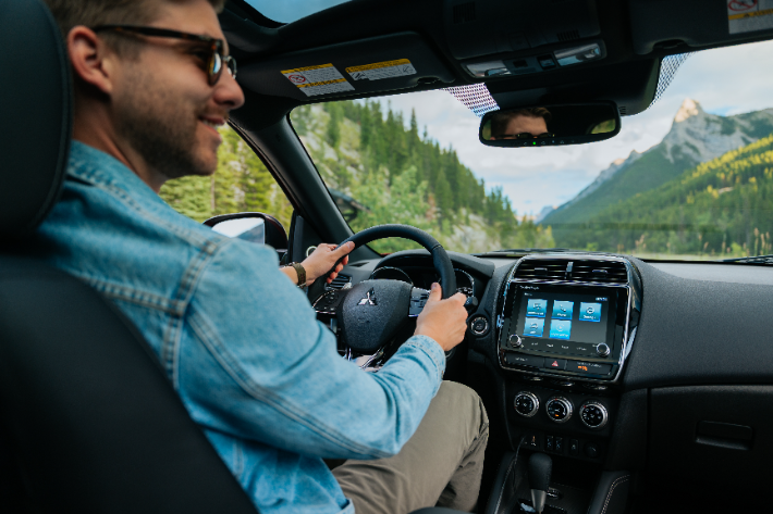 A smiling man driving the RVR