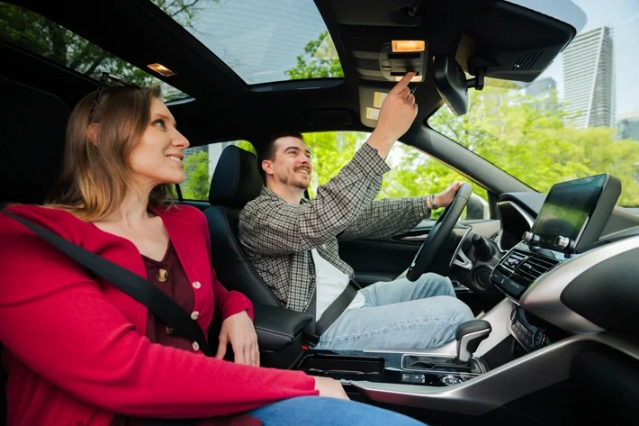 A man opening the panoramic sunroof in the Eclipse Cross
