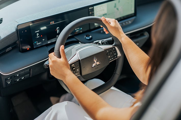 A woman driving the Eclipse Sportback